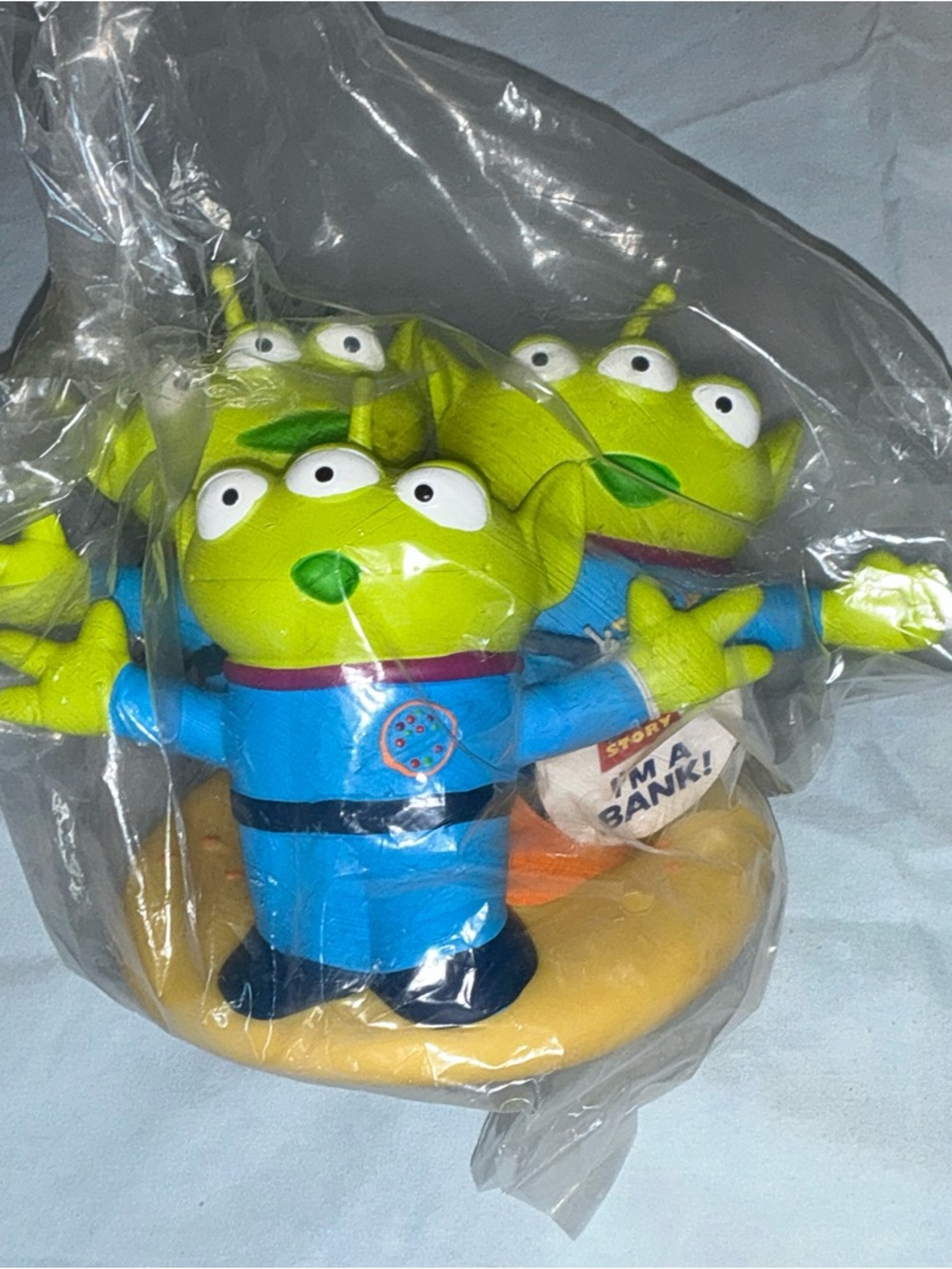 The Claw Green Alien Toy Coin Bank Blue Outfit Standing